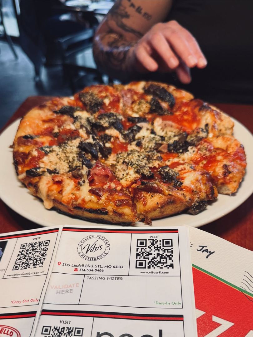 A pizza served on top of the open passport coupon page